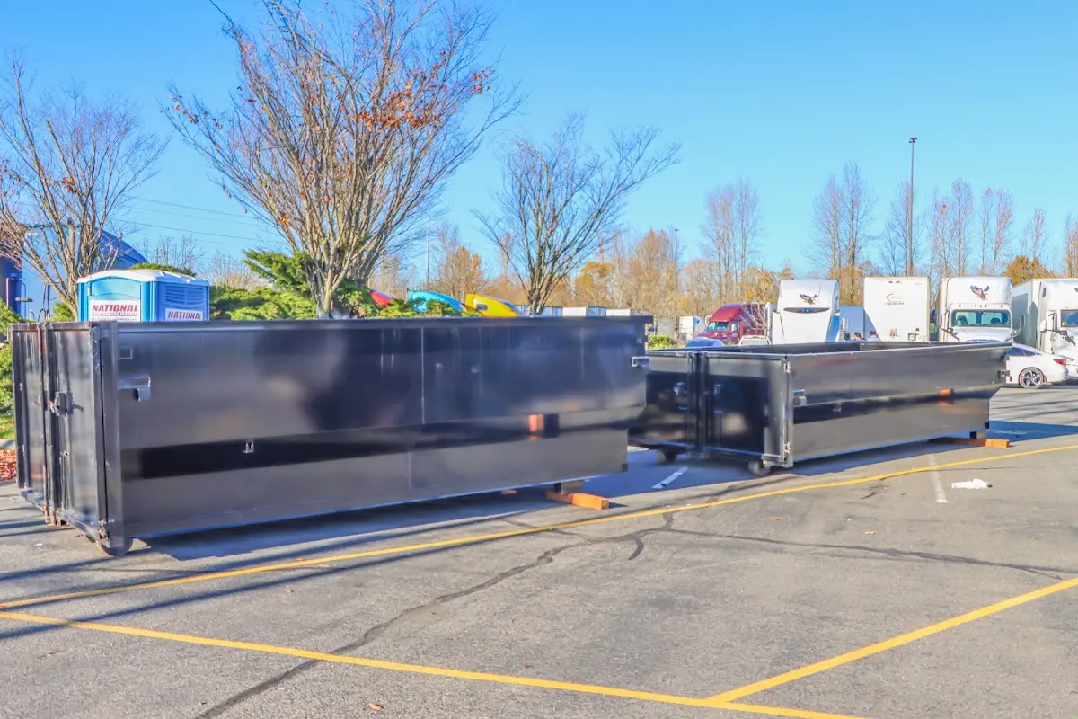 Professional dumpster rental service with roll-off container on residential driveway in Hyrum